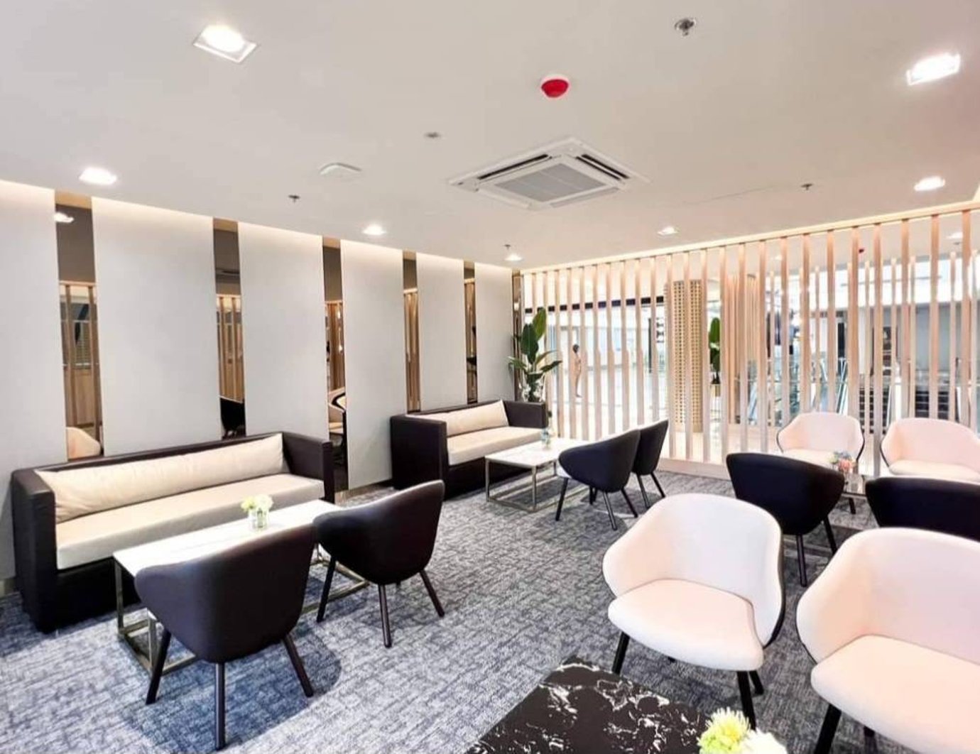 Modern seating area at Miracle Business Class Lounge Satellite 1 Bangkok Suvarnabhumi Airport featuring soft armchairs, sofas, and bright contemporary décor.