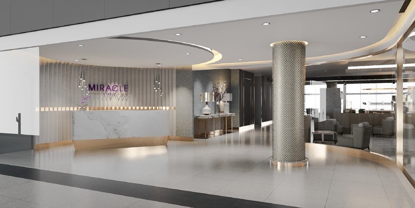Entrance to Miracle First Class Lounge Satellite 1 Bangkok Suvarnabhumi Airport featuring a sleek marble reception desk, modern lighting, and elegant décor.