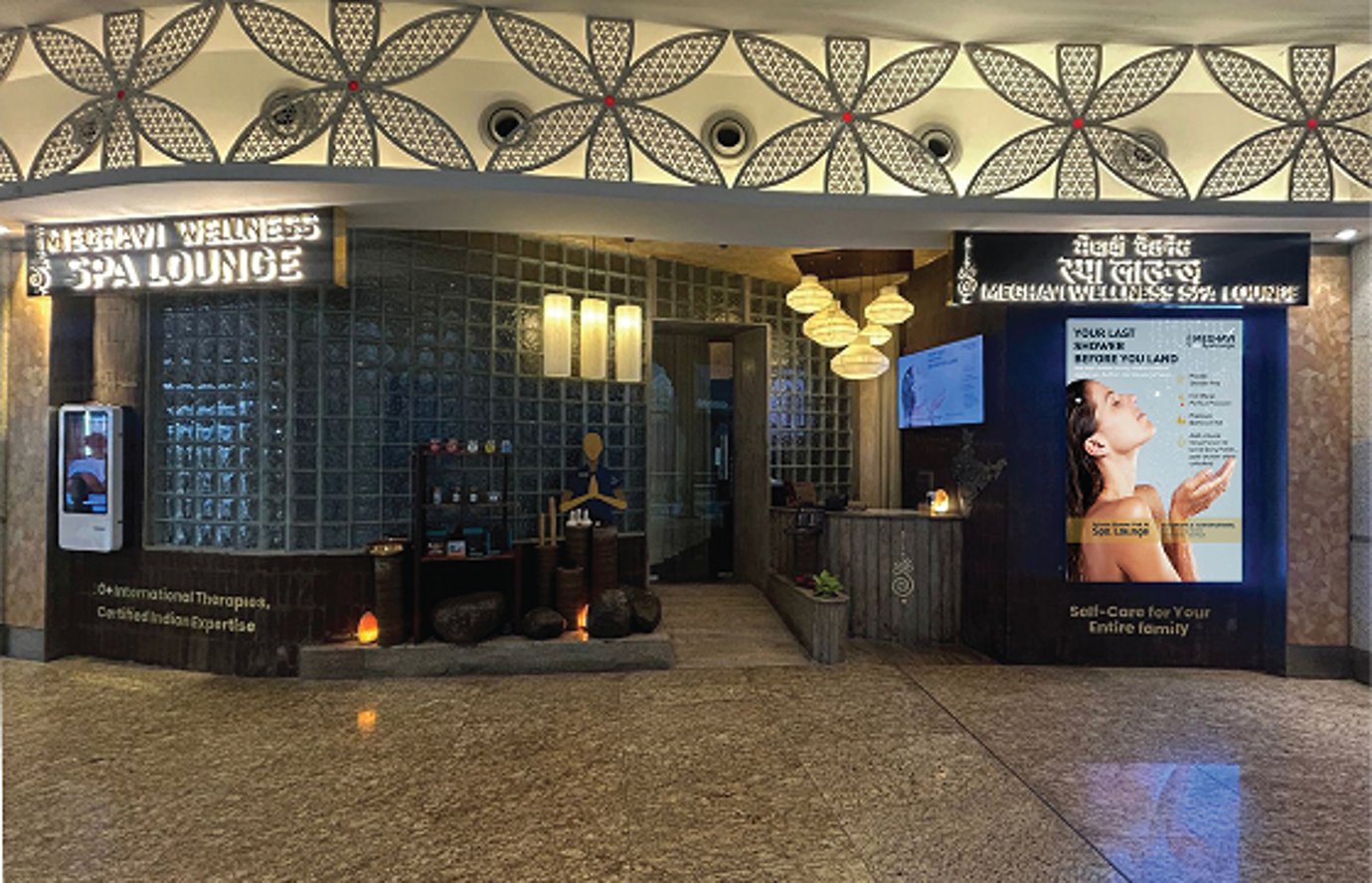Meghavi Wellness & Spa Lounge entrance at Mumbai Airport with illuminated signage and relaxing décor. Meghavi Wellness & Spa Lounge entrance at Mumbai Airport with illuminated signage and relaxing décor.
