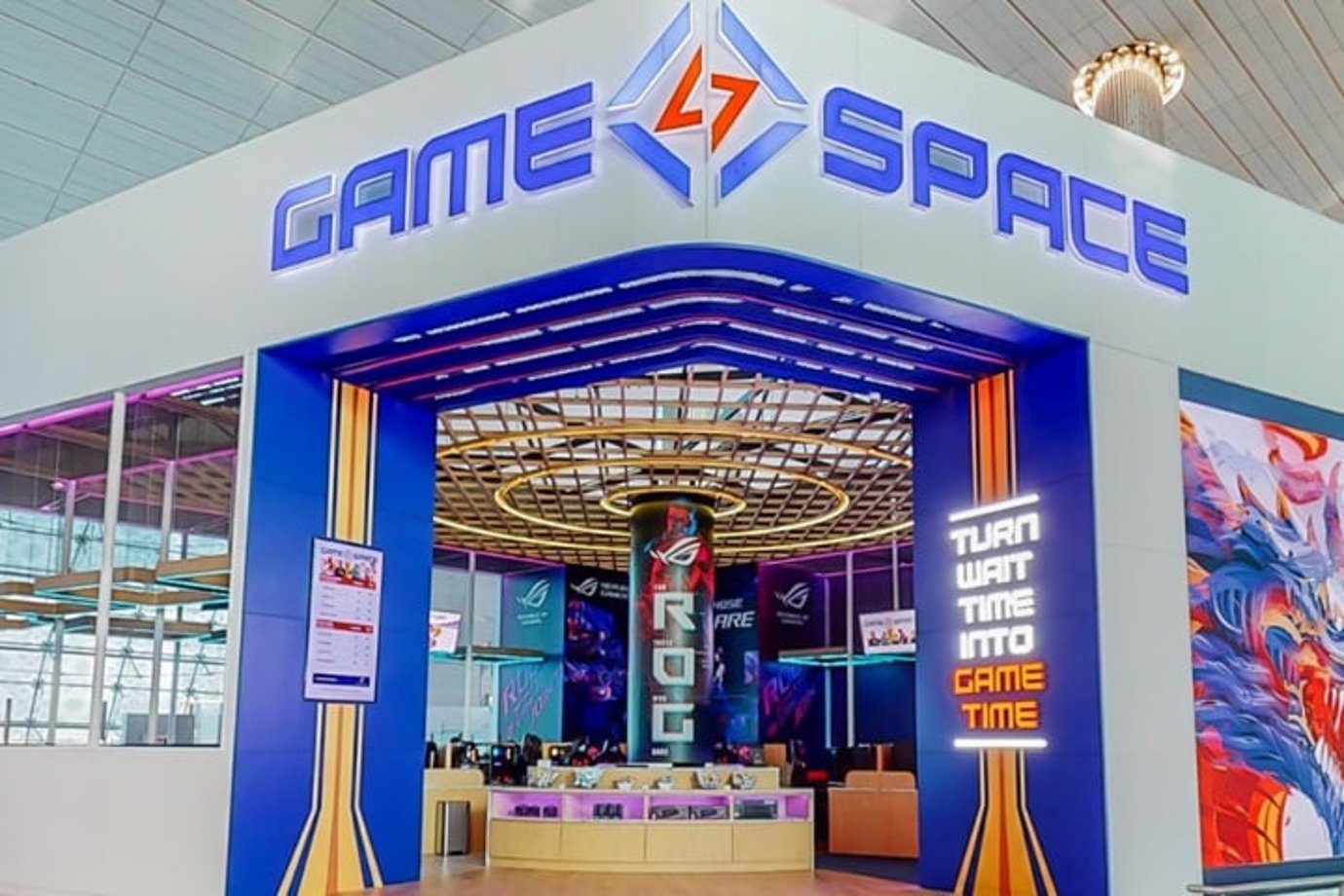 Dubai Airport Game Space gaming lounge with illuminated entrance, colourful lighting, and PC gaming stations for guests. Dubai Airport Game Space gaming lounge with illuminated entrance, colourful lighting, and PC gaming stations for guests.