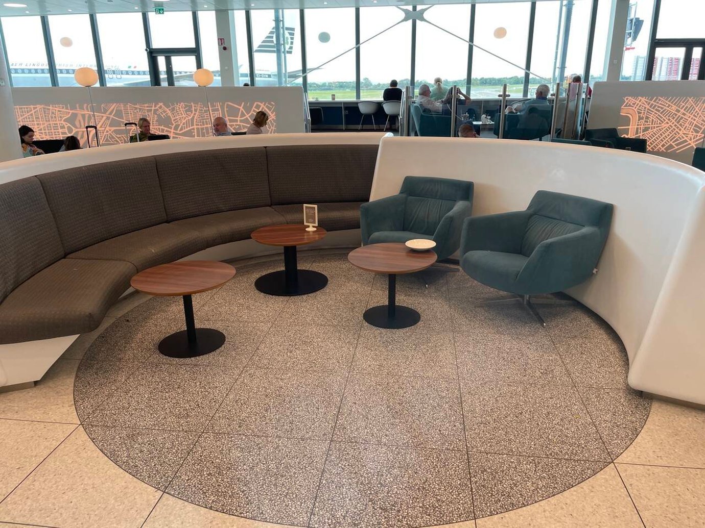 Luxurious 51st & Green Lounge at Dublin Airport with a curved sofa and chic coffee tables for travelers. Luxurious 51st & Green Lounge at Dublin Airport with a curved sofa and chic coffee tables for travelers.