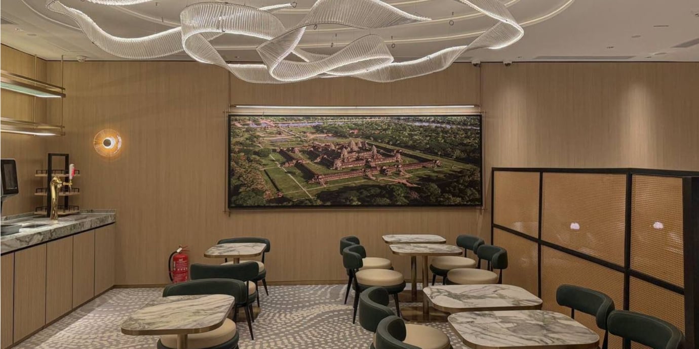 The seating area in Plaza Premium Lounge at Techo International Airport features marble tables and cushioned chairs with a decorative wall display. The seating area in Plaza Premium Lounge at Techo International Airport features marble tables and cushioned chairs with a decorative wall display.