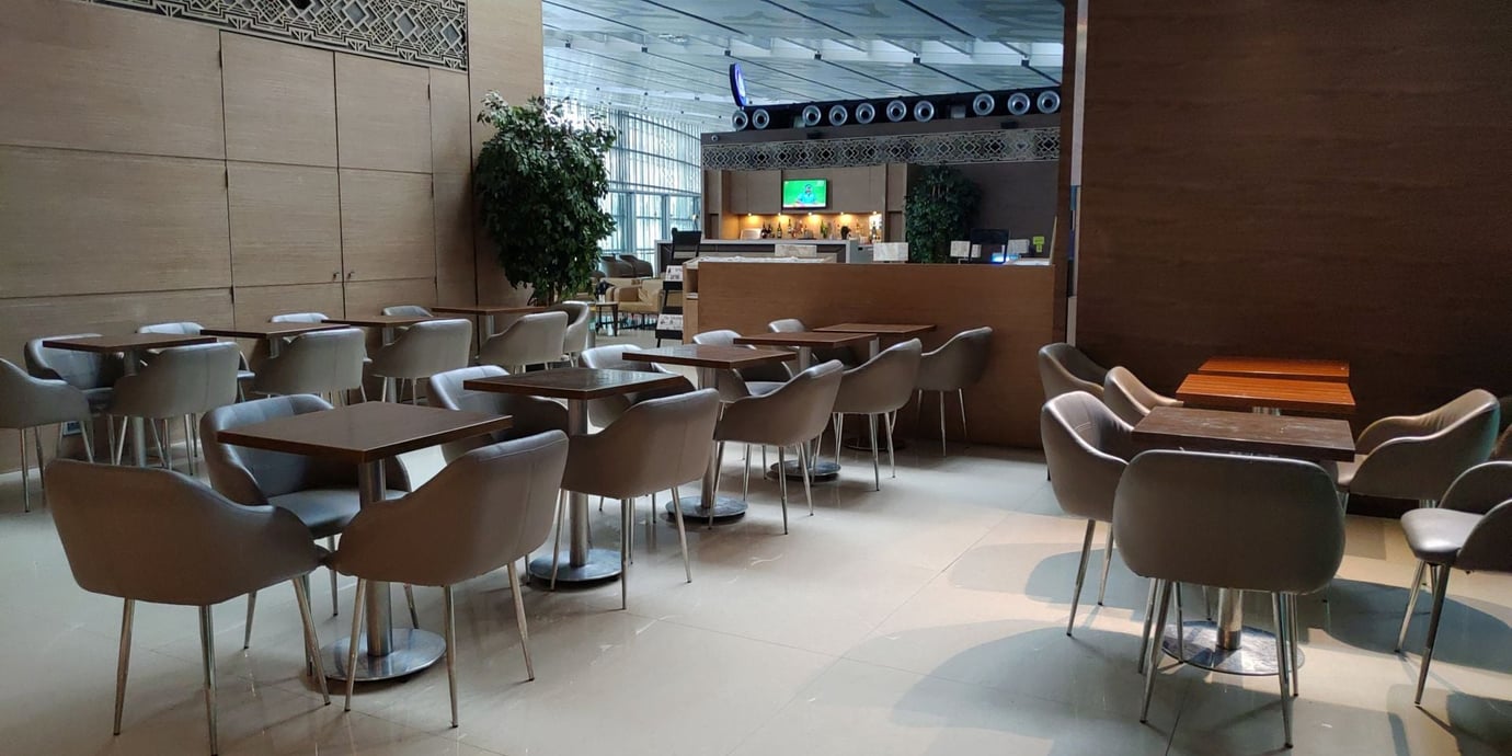 Travel Club Lounge dining space at Kolkata Airport (CCU) with modern seating and tables. Travel Club Lounge dining space at Kolkata Airport (CCU) with modern seating and tables.