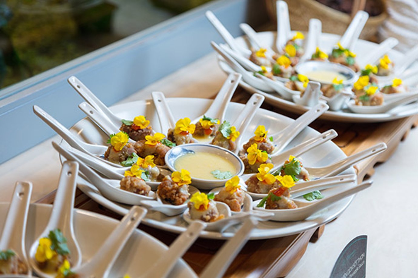 Individual tasting spoons with bite-size appetizers and dipping sauce at Le Saigonnais Lounge buffet. Individual tasting spoons with bite-size appetizers and dipping sauce at Le Saigonnais Lounge buffet.