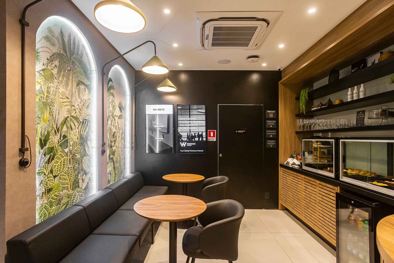 Inside W Café Lounge at Palmas–Brigadeiro Lysias Rodrigues Airport (PMW), showing the sleek seating area with botanical wall art, contemporary lighting, and a snack buffet setup. Inside W Café Lounge at Palmas–Brigadeiro Lysias Rodrigues Airport (PMW), showing the sleek seating area with botanical wall art, contemporary lighting, and a snack buffet setup.
