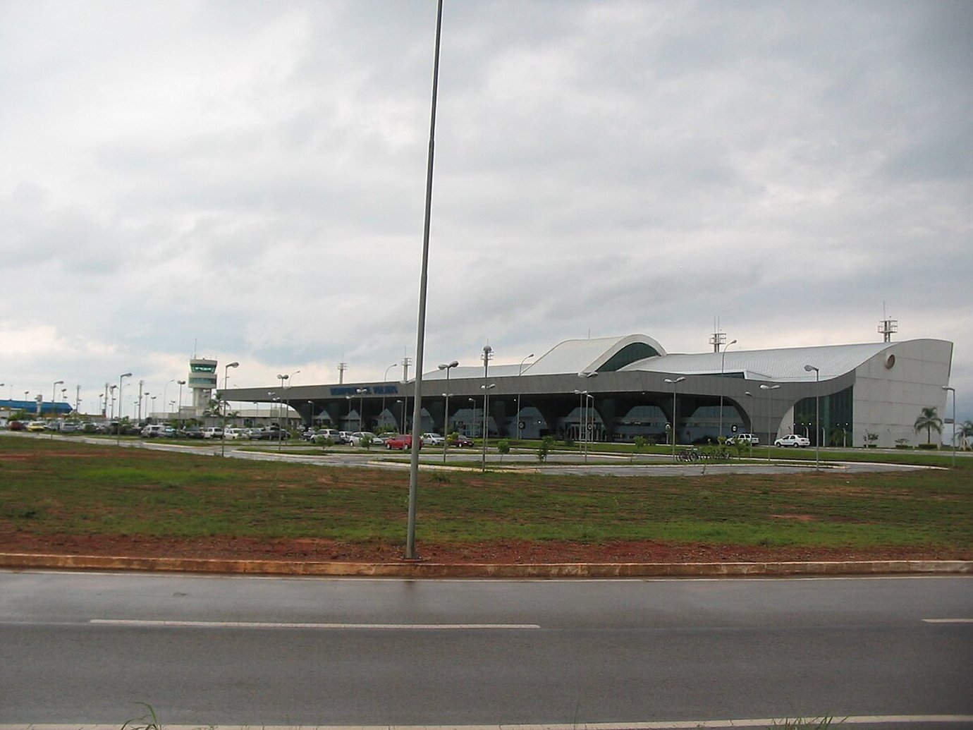 Wide exterior view of Palmas–Brigadeiro Lysias Rodrigues Airport in Brazil, showing its modern curved terminal building under cloudy skies. Wide exterior view of Palmas–Brigadeiro Lysias Rodrigues Airport in Brazil, showing its modern curved terminal building under cloudy skies.