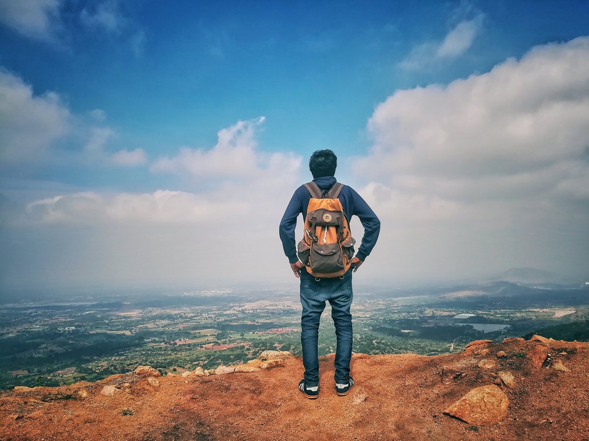 Image of traveller standing on edge of cliff