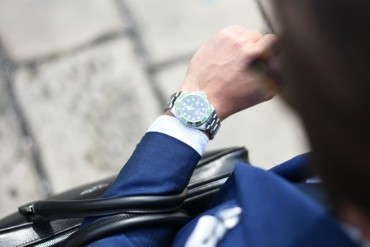 Business executive looking at watch