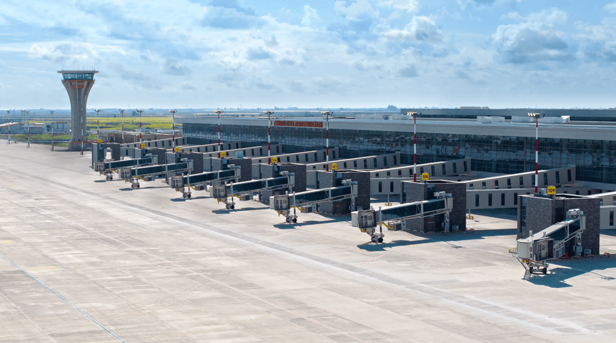 Image of the exterior of Mersin çukurova international COV airport showing the tarmac and terminals.