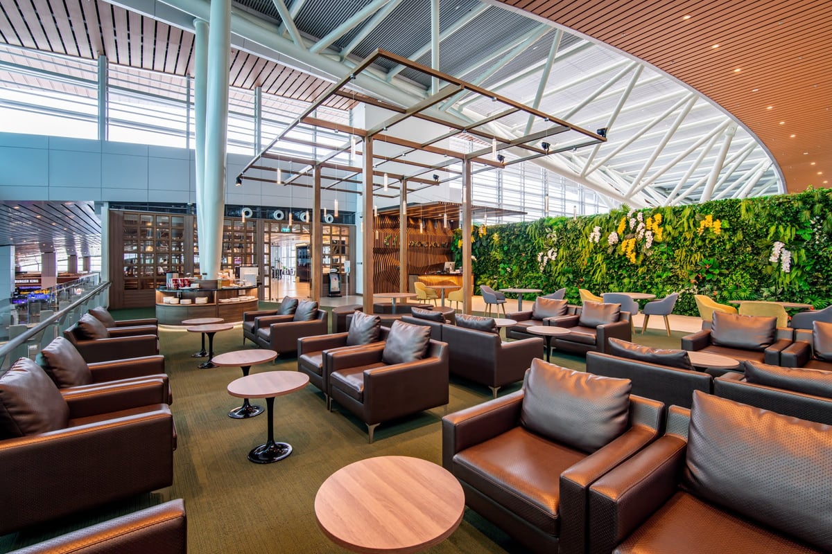 Spacious seating area at CIP Orchid Lounge 1 in Da Nang International Airport Terminal 2, featuring modern leather armchairs, greenery wall, and open-air design with natural lighting