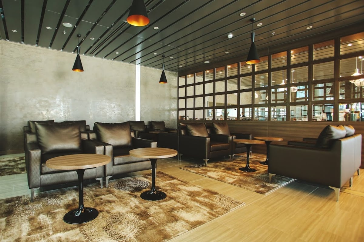 Comfortable leather armchairs and modern pendant lighting in the quiet seating area of CIP Orchid Lounge 1, Da Nang International Airport Terminal 2