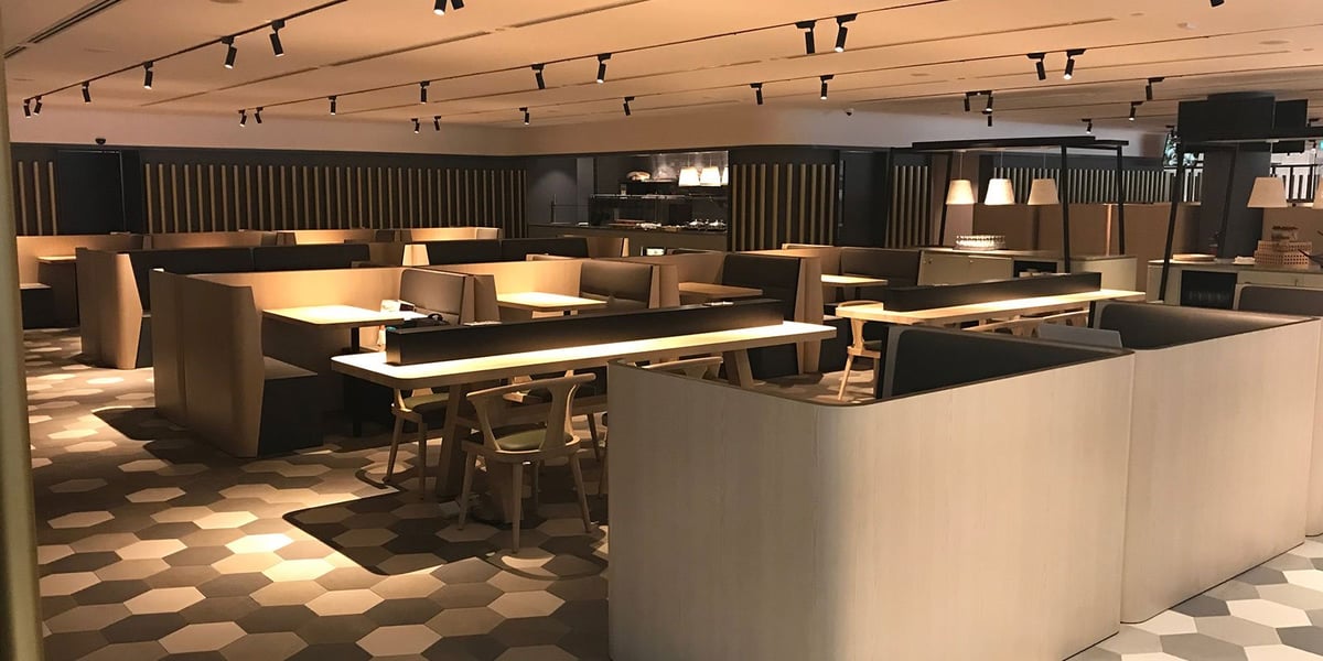 Blossom Lounge at Changi Airport Terminal 4 Singapore with modern booth seating, warm lighting and stylish dining area.