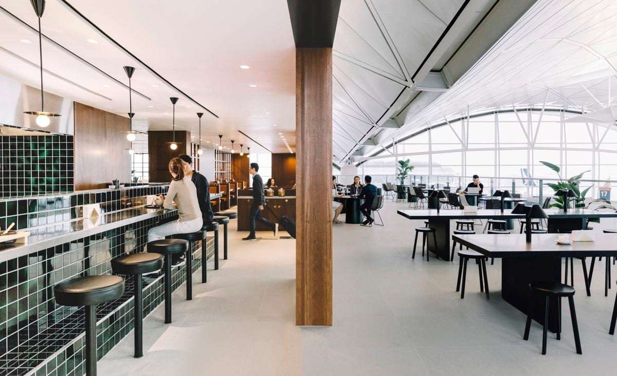 Cathay Pacific The Deck lounge at Hong Kong International Airport with noodle bar, modern seating, and panoramic runway views