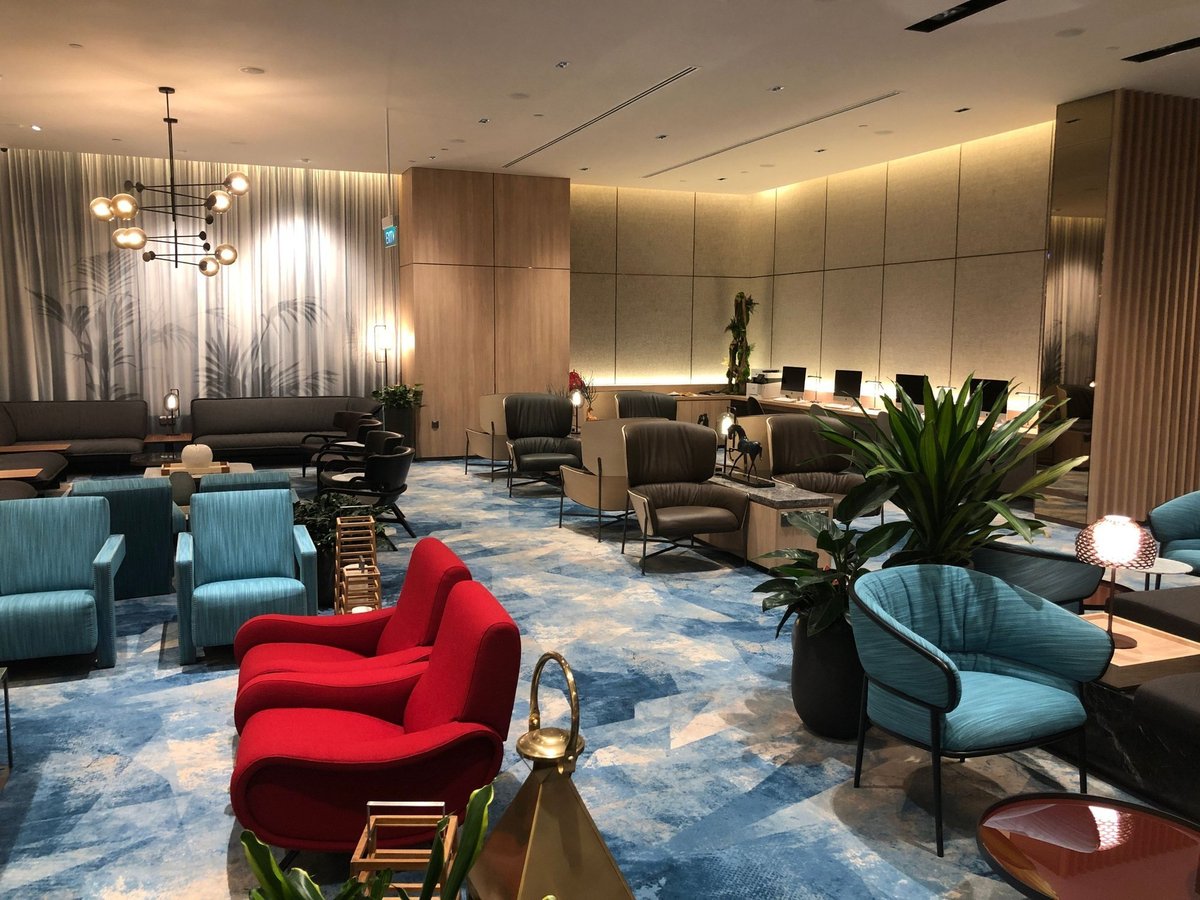Stylish seating area with modern armchairs and workstations at Changi Lounge, Jewel Changi Airport Singapore.