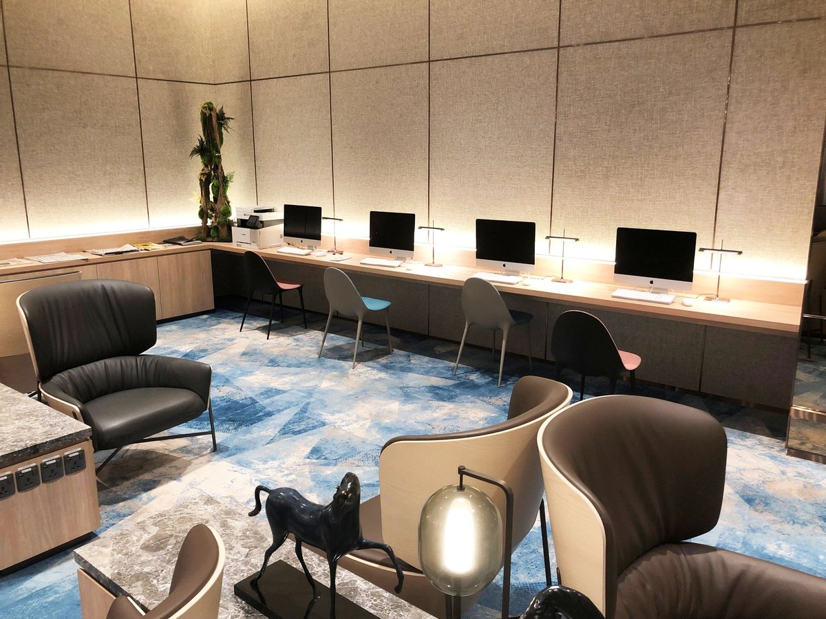 Business centre with iMac computers and modern seating at Changi Lounge, Jewel Changi Airport Singapore.