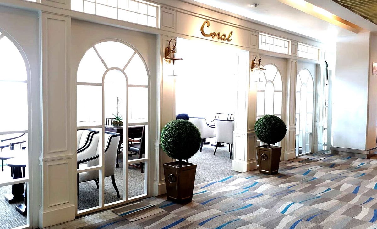 Interior of The Coral Executive Lounge Beach Lounge at Phuket Airport with stylish chairs and serene decor.