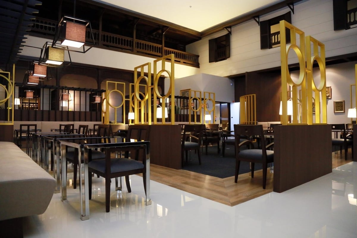 Miracle Lounge No2 at terminal 1 of Don Mueang International airport. Elegant lounge designed with traditional Thai architectural elements. Walls are adorned with framed artwork transitions from glossy white tiles to wooden planks.