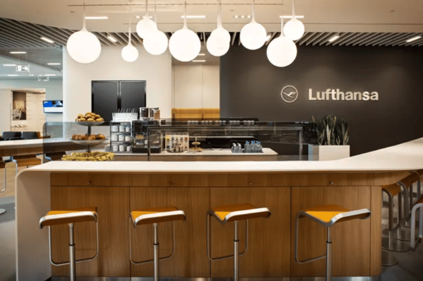 Bar seating area nearby food buffet in Lufthansa airport lounge Frankfurt