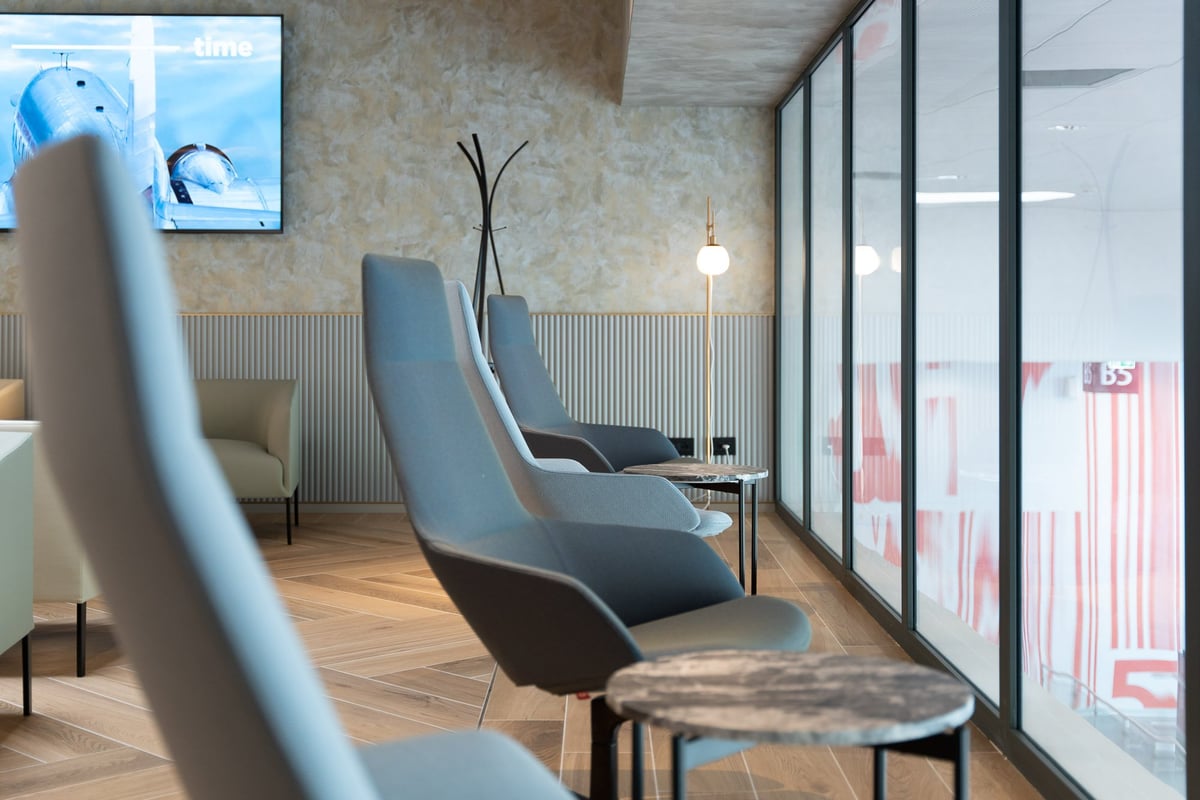 Close up photos of stylish chairs overlooking the terminal at Milan HelloSky Lounge