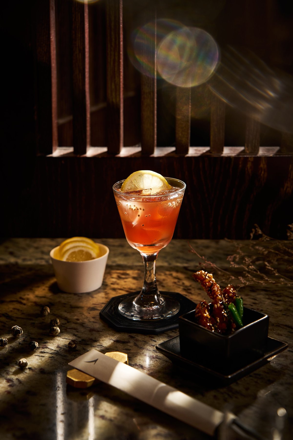 Hong Kong iced tea at the Cathay Pacific The Pier First Lounge served in a stemmed glass with a lemon slice.