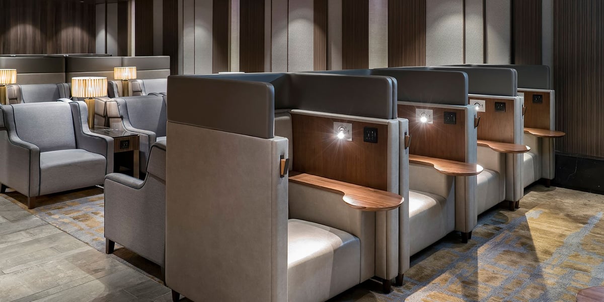 Grey and beige seating pods at the Hong Kong plaza premium lounge gate 1.