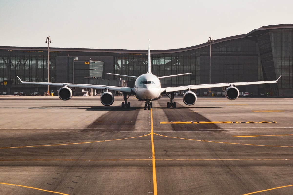 Airplane on a runway outside of a European airport terminal