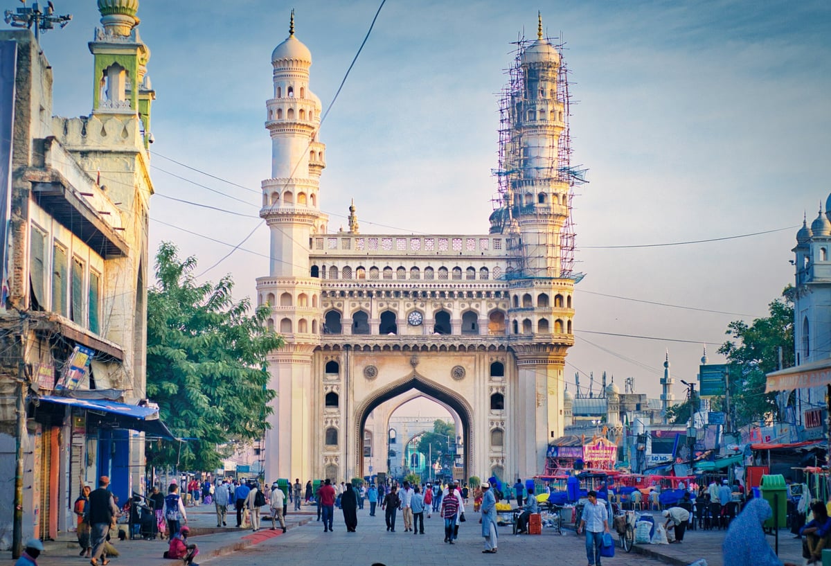 The iconic Charminar in Hyderabad, India, captured during daytime with bustling street life.