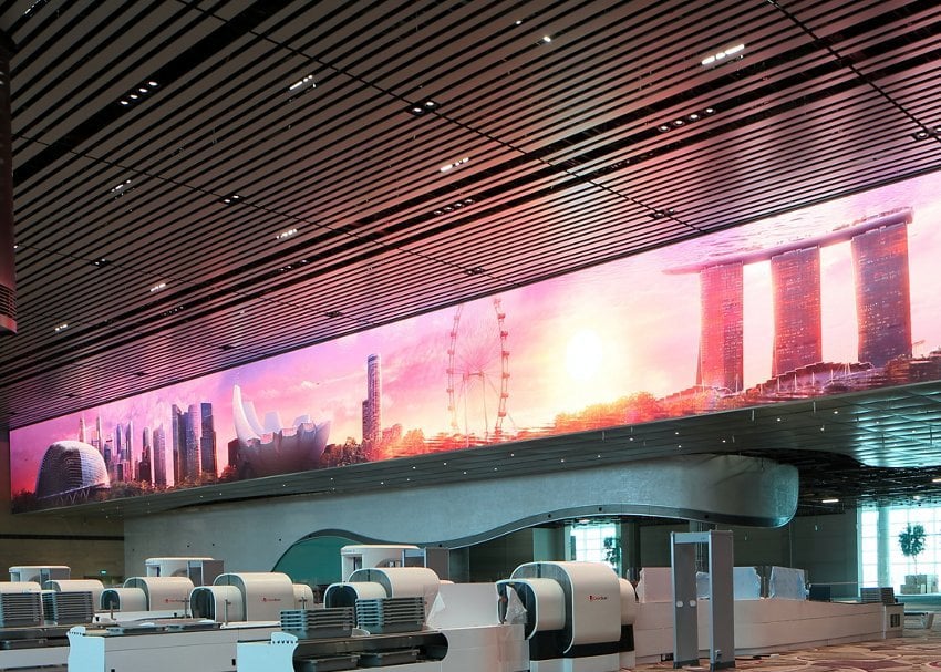 Immersive digital wall at Changi Airport Terminal 4 Singapore, featuring skyline view with Marina Bay Sands, Singapore Flyer and city landmarks.