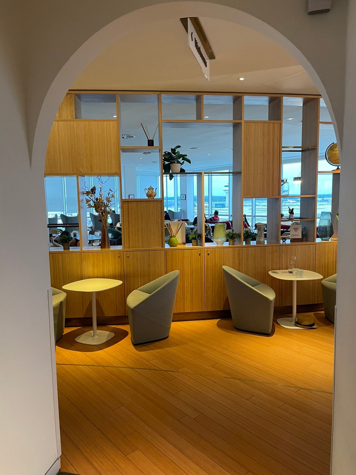 Seating and Small Tables along a feature see-through wall at the Plaza Premium Lounge Gatwick