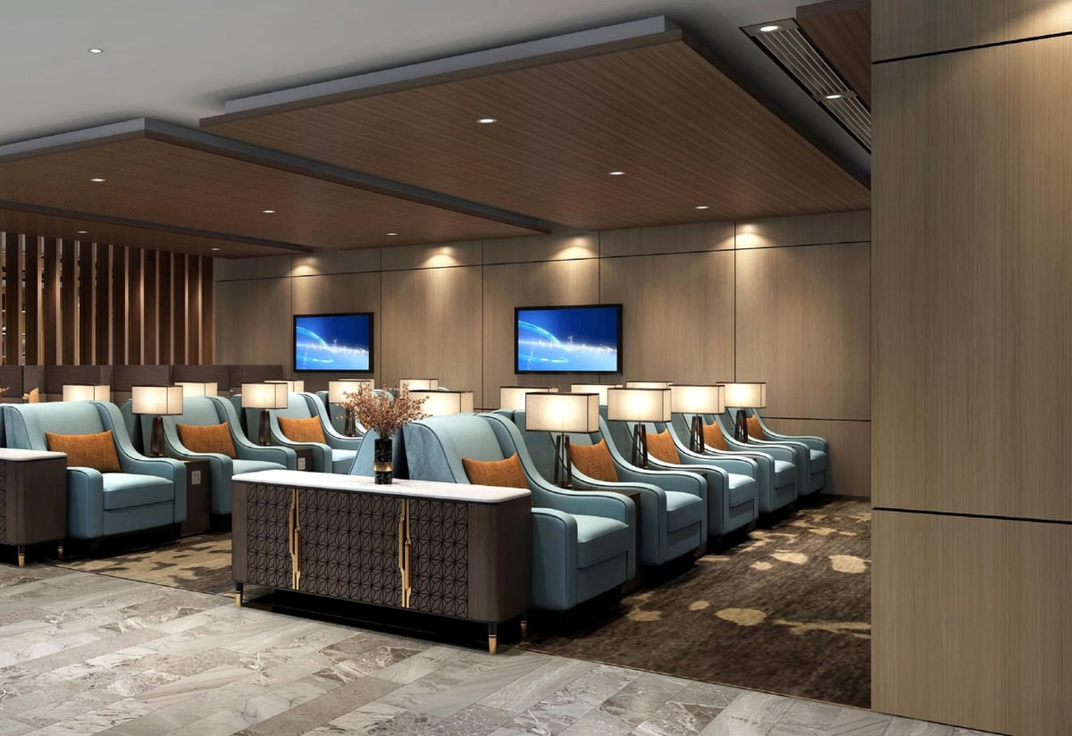 The sophisticated seating area of the Plaza Premium V1 Lounge in Qingdao, featuring luxurious aqua and tan reclining seats, stylish lamps, and wood-paneled walls for a contemporary and relaxing atmosphere.