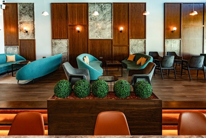 Seating nearby wood panel wall at Primeclass Lounge Skopje International Airport