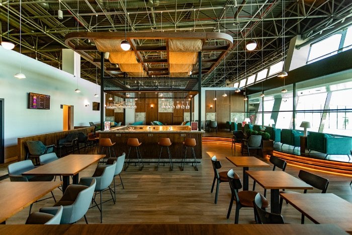 Table seating nearby bar area in Primeclass Lounge Skopje International Airport