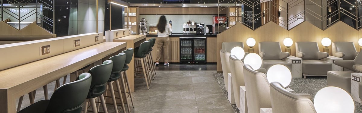 Modern airport lounge bar with high chairs, adjacent plush seating area, at the Plaza Premium Lounge Sabiha (Domestic).