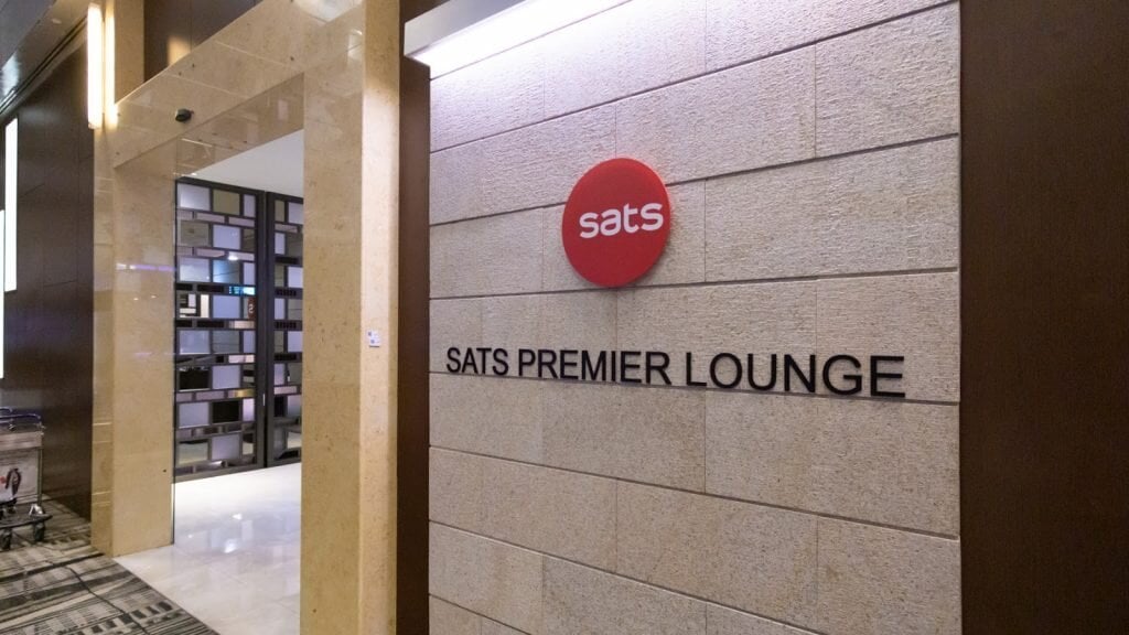 Entrance to SATS Premier Lounge at Singapore Changi Airport Terminal 3, featuring modern stone wall design and lounge signage.