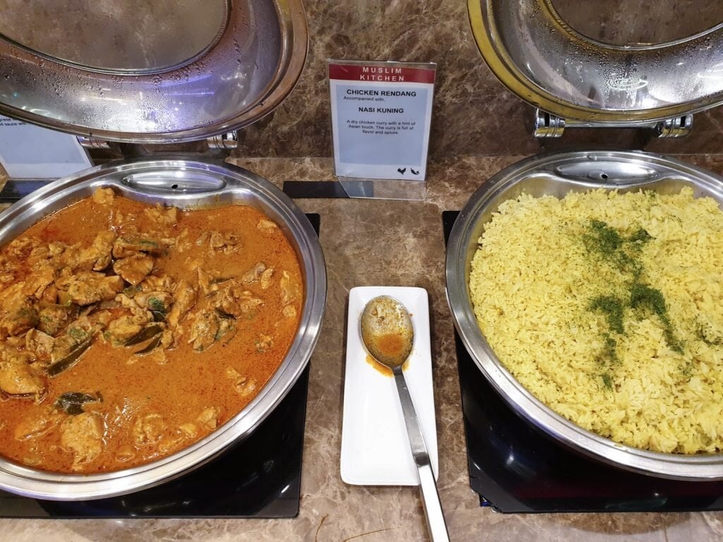 Buffet selection of Chicken Rendang and Nasi Kuning served at SATS Premier Lounge in Singapore Changi Airport Terminal 3.