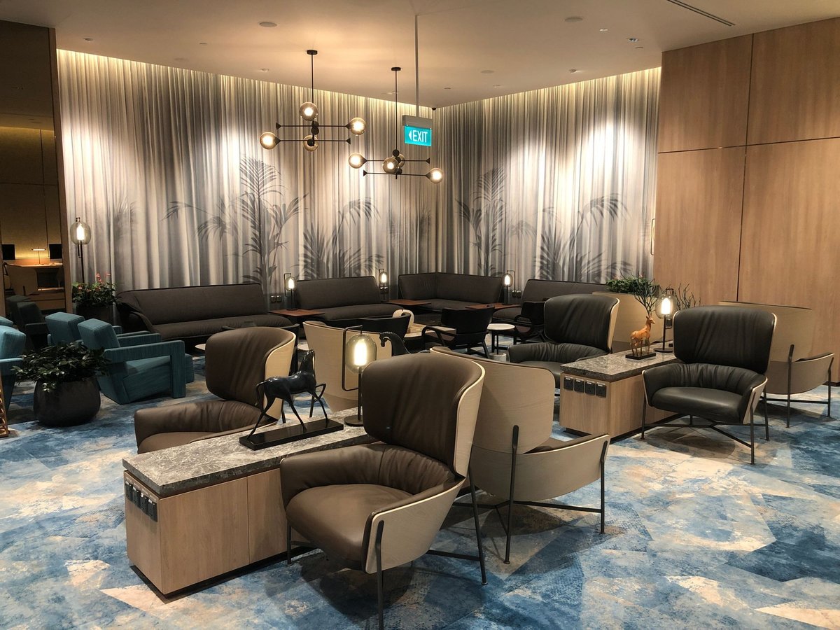 Comfortable seating area with modern armchairs and sofas at Changi Lounge, Jewel Changi Airport Singapore.