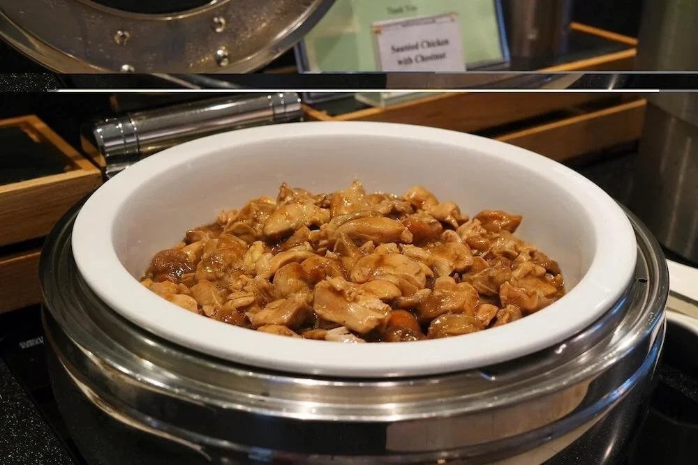 Serving dish of sautéed chicken with chestnut at KrisFlyer Gold Lounge in Singapore Changi Airport Terminal 3.