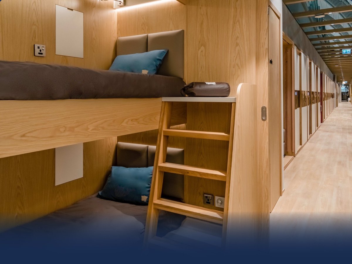 An image of the YAWN Family Bunk Cabin, showing two bunks and access ladder, at Sleep n Fly Concourse C Doha Hamad International Airport.