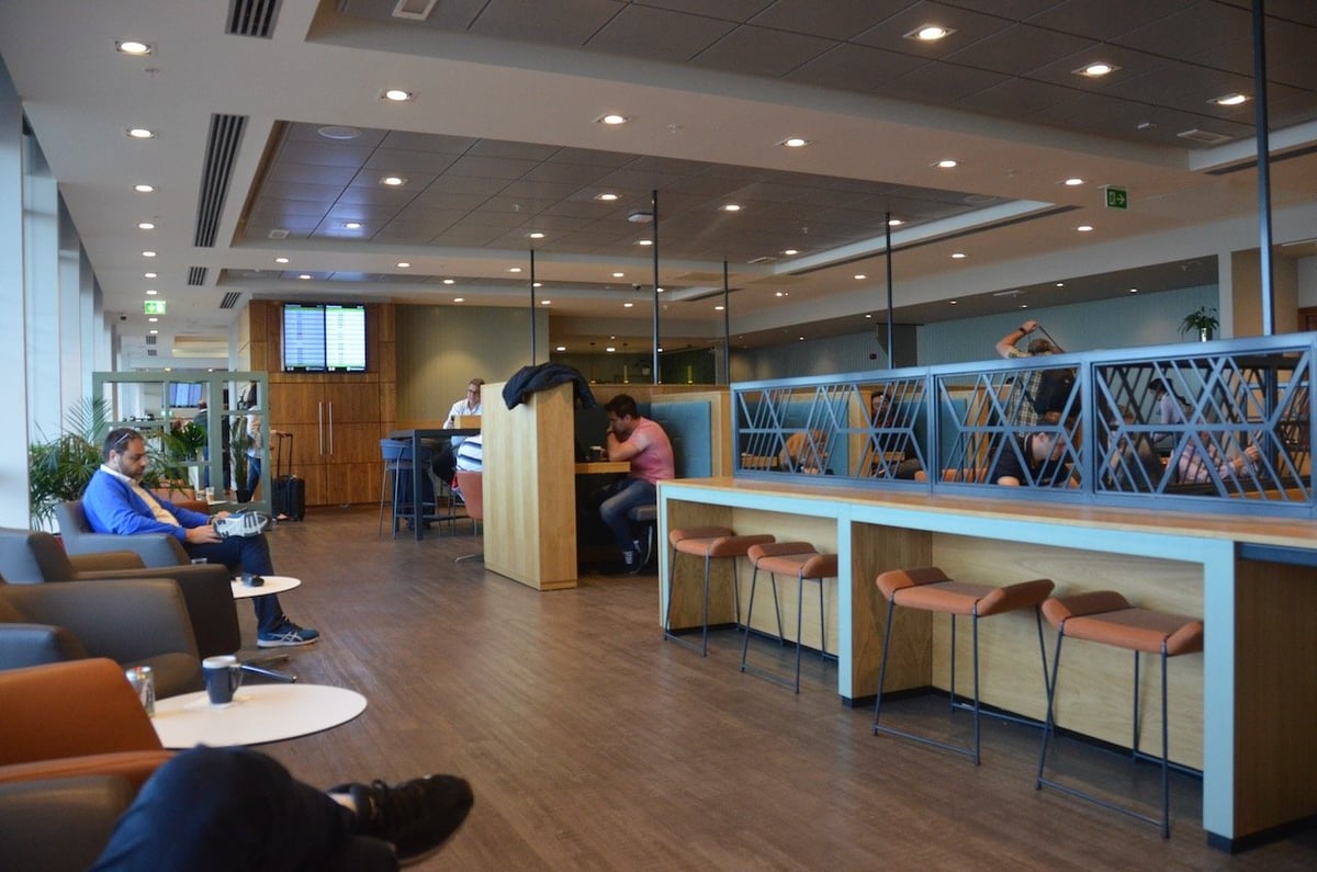 Travelers relaxing in the spacious T1 Lounge at Dublin Airport with comfortable seating and modern decor.