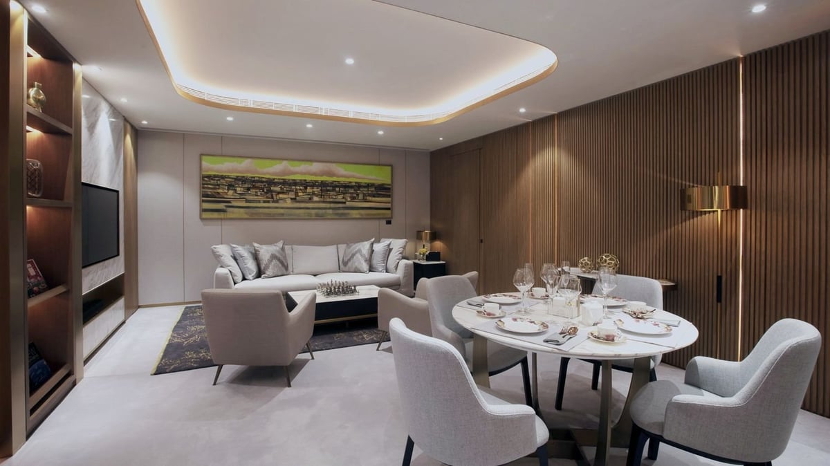 Spacious seating area at HKIA VIP Lounge featuring plush armchairs, elegant lighting, patterned carpet, and a tranquil ambiance designed for luxury and privacy at Hong Kong International Airport.