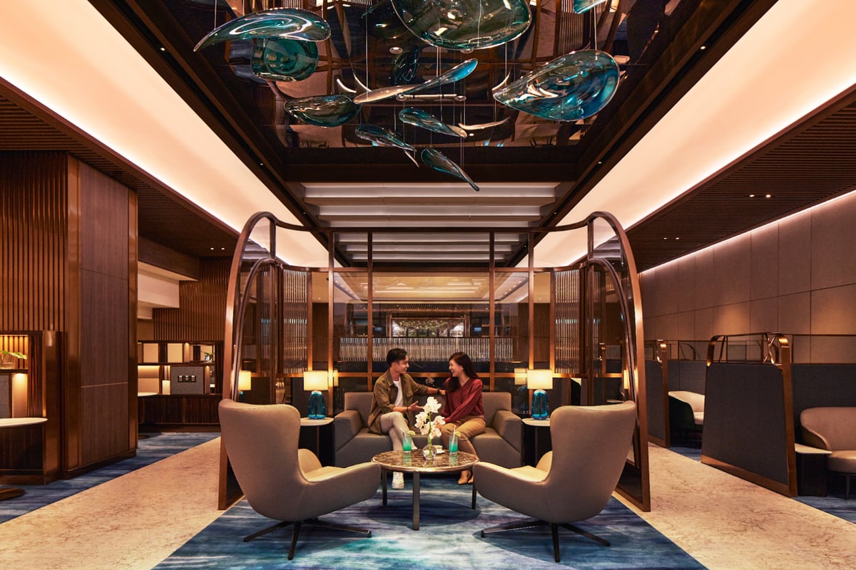 Luxurious seating area inside The Private Room at Singapore Changi Airport, featuring modern armchairs, ambient lighting, and elegant decor for first-class travelers.
