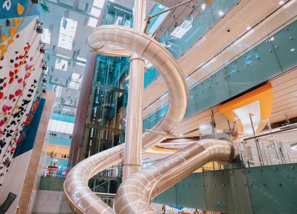World’s tallest airport slide at Changi Airport Terminal 3 Singapore with multi-level spiral design and adventure play area.