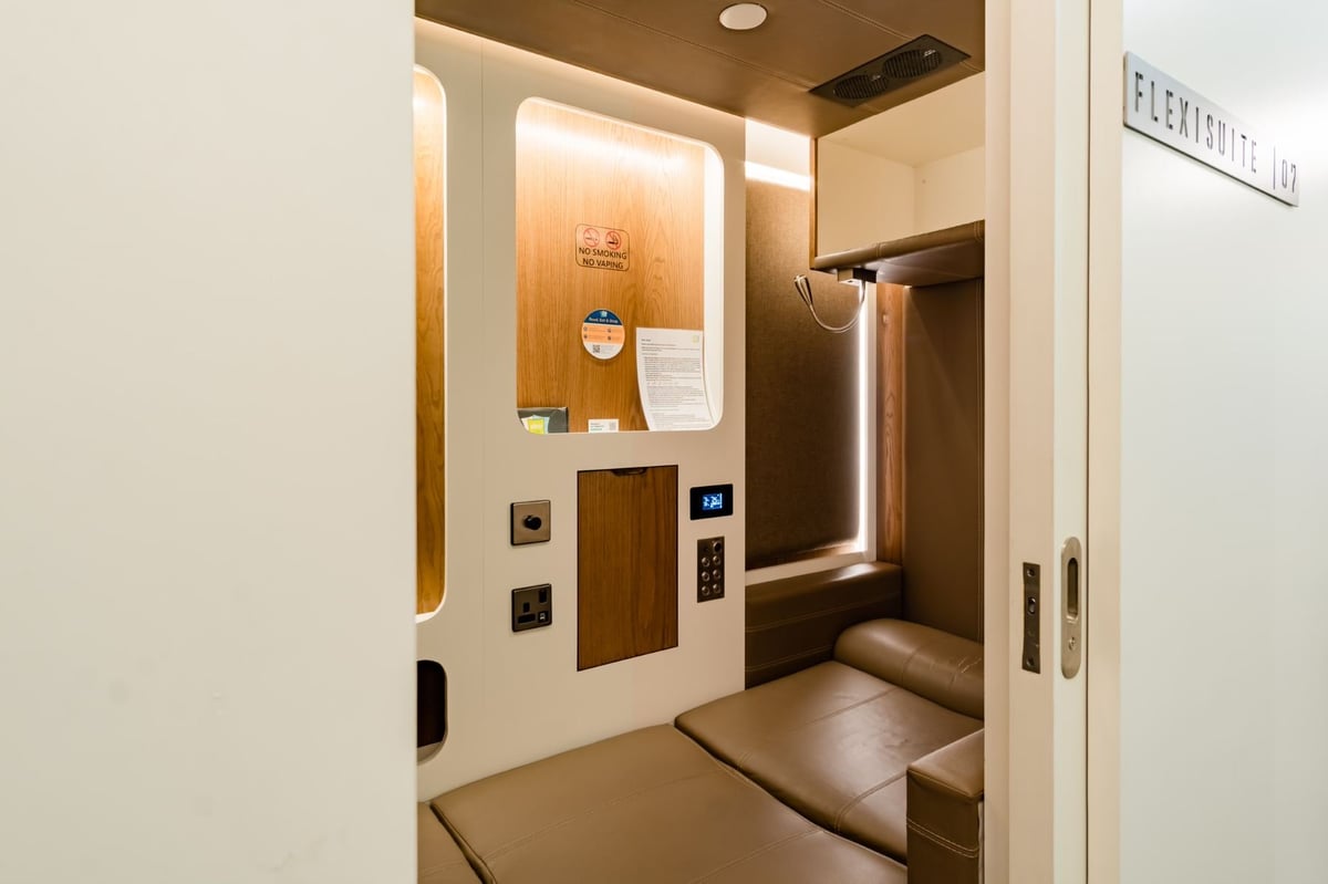 Flexisuite pod at sleep 'n fly DXB Airport with bed lying down and light on