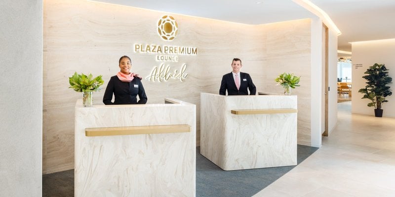 Reception Area of the plaza premium lounge at Adelaide airport featuring sleek marble countertops  and a neutral colour palette