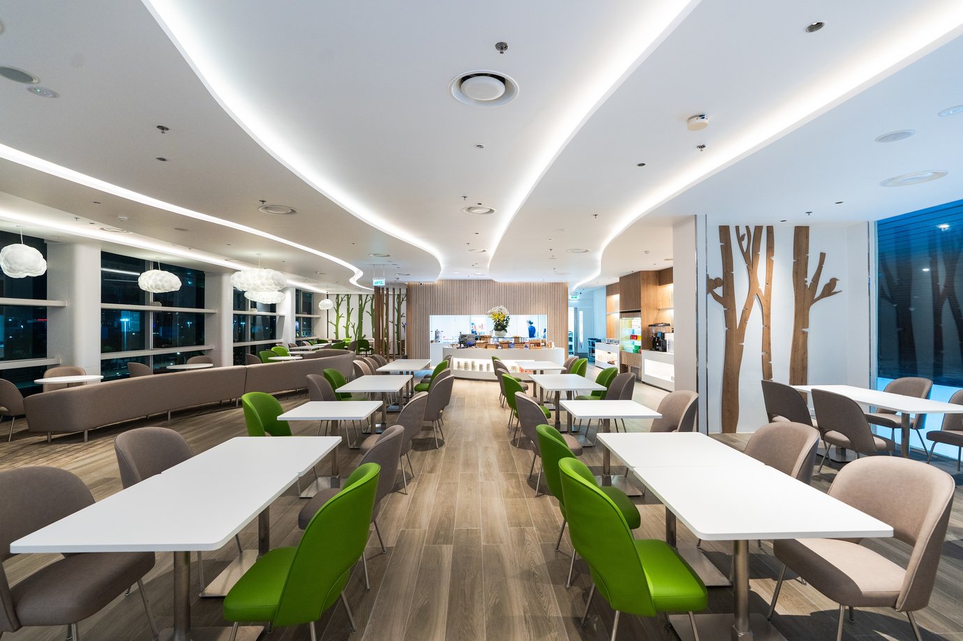 Spacious dining area inside Vanda Lounge at Da Nang International Airport Terminal 2, featuring modern lighting, wood flooring, and green-accent seating. Spacious dining area inside Vanda Lounge at Da Nang International Airport Terminal 2, featuring modern lighting, wood flooring, and green-accent seating.