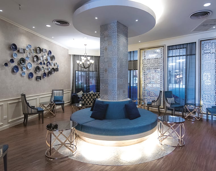 Bangkok Airways Blue Ribbon Lounge seating area at Chiang Mai Airport with modern decor and circular sofa.