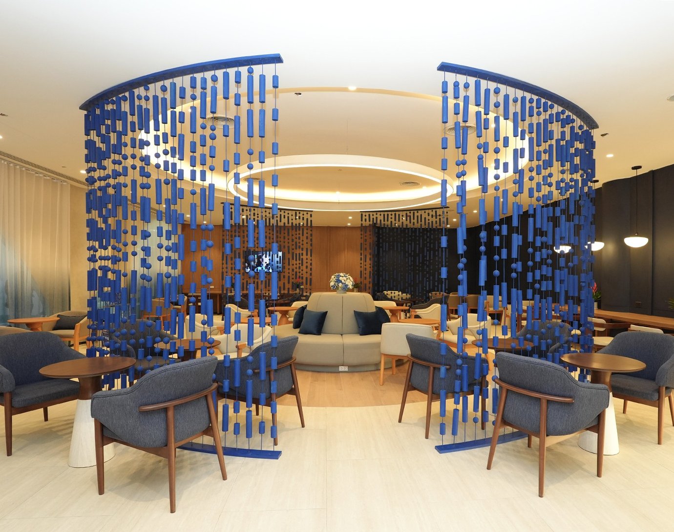 Don Mueang Airport boutique lounge seating area with modern chairs and decorative blue partition.
