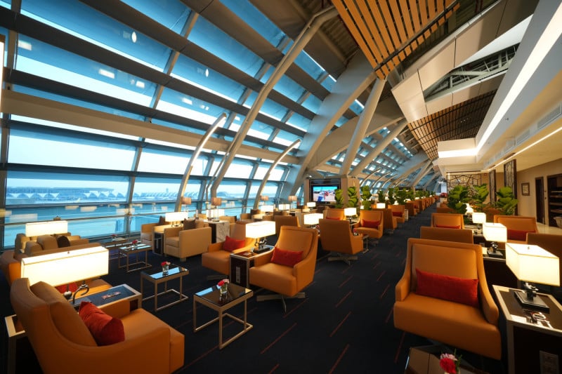 Spacious Emirates Lounge Satellite 1 Bangkok Suvarnabhumi Airport featuring premium leather seating, ambient lighting, and floor-to-ceiling windows overlooking the runway. Spacious Emirates Lounge Satellite 1 Bangkok Suvarnabhumi Airport featuring premium leather seating, ambient lighting, and floor-to-ceiling windows overlooking the runway.