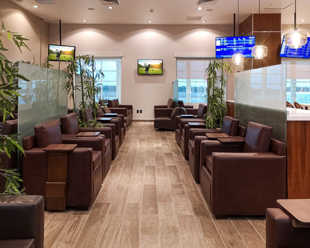 VIP Lounge by Mera Terminal 2 at Cancun International Airport seating area with rows of armchairs, side tables, and a quiet lounge space. VIP Lounge by Mera Terminal 2 at Cancun International Airport seating area with rows of armchairs, side tables, and a quiet lounge space.