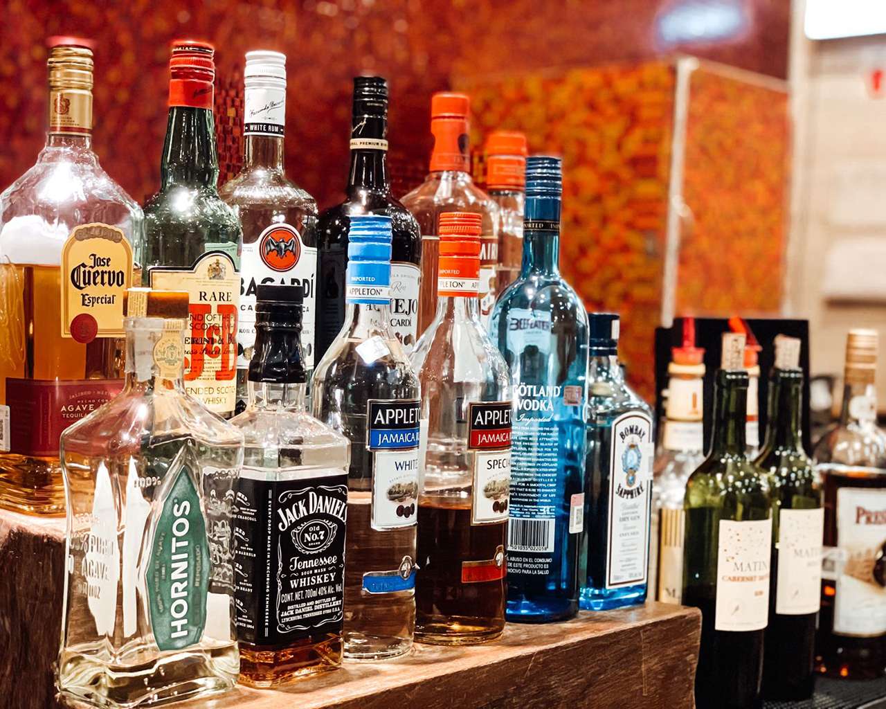 VIP Lounge by Mera at Cancun International Airport bar selection with bottles of spirits, wine, and liquor displayed on a counter. VIP Lounge by Mera at Cancun International Airport bar selection with bottles of spirits, wine, and liquor displayed on a counter.